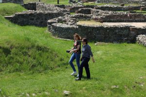 Two women are walking through Felix Romuliana complex.