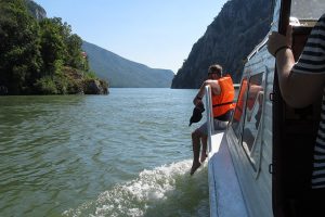 A guy enjoys in the boat ride trough the iron gate gorge.