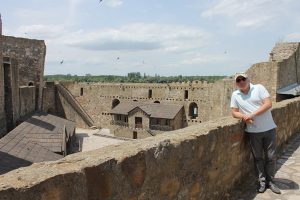 A man in light blue shirt is posing on Smederevo fortress.